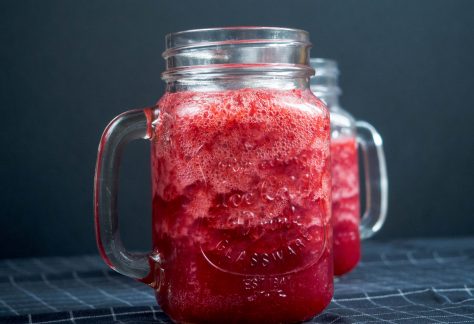 Mason jar mugs filled with red smoothie