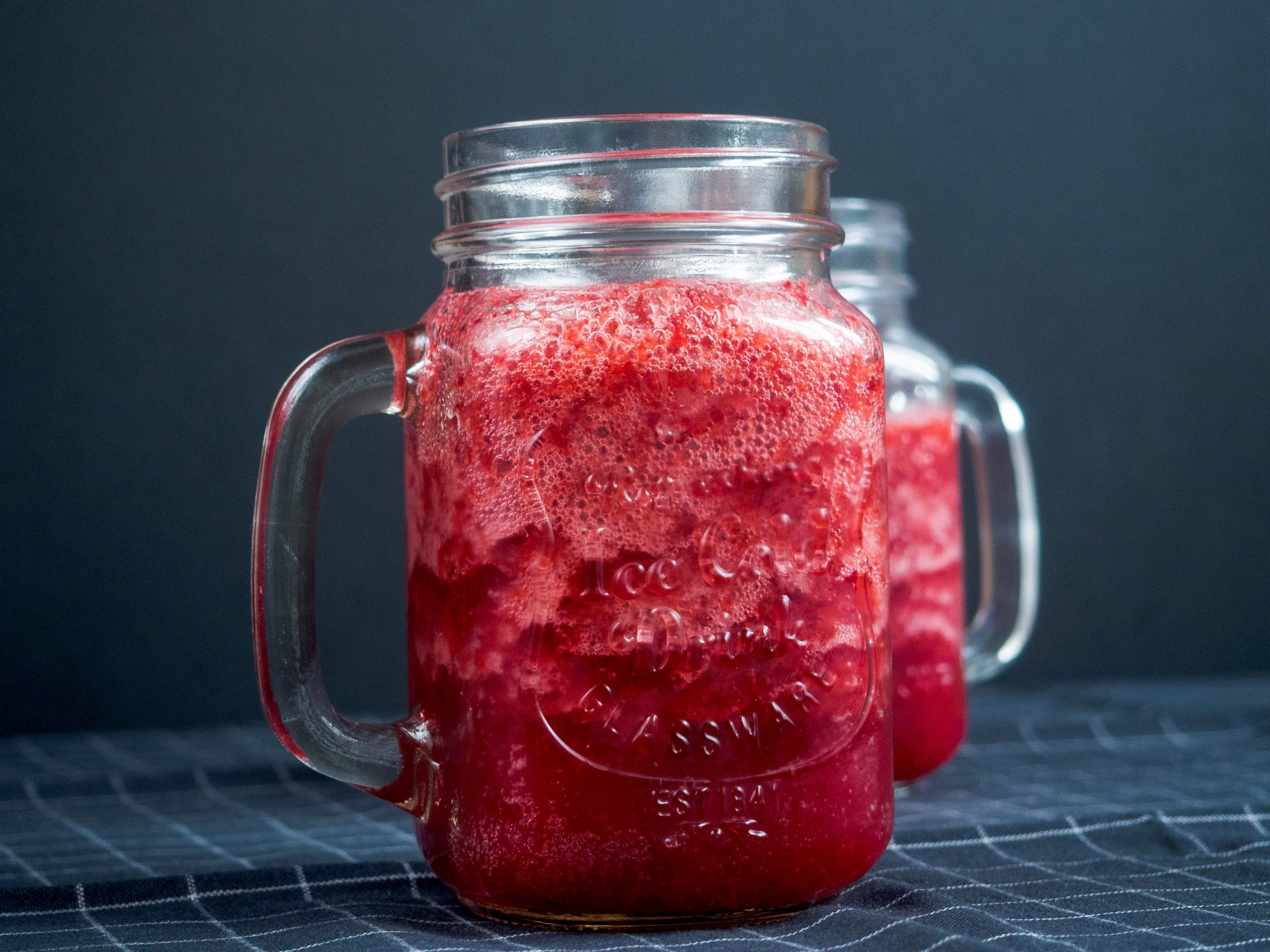 Mason jar mugs filled with red smoothie